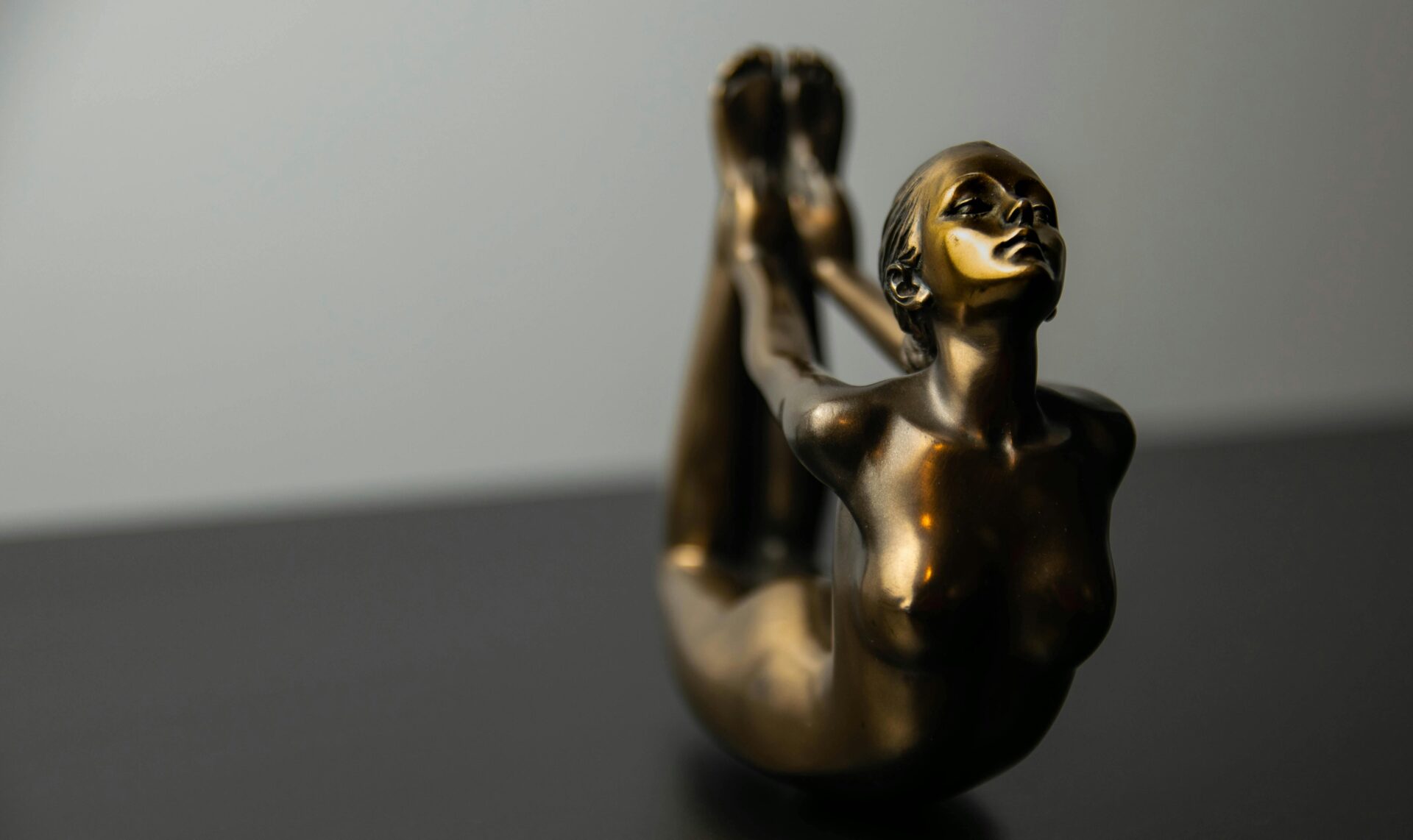 studio-shot-of-a-bronze-figurine-of-a-exercising-girl