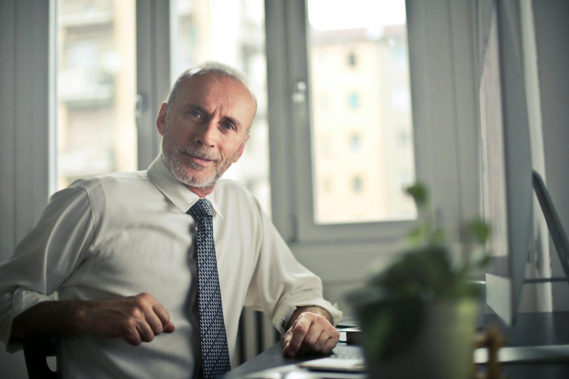 man-sitting-on-chair-beside-table