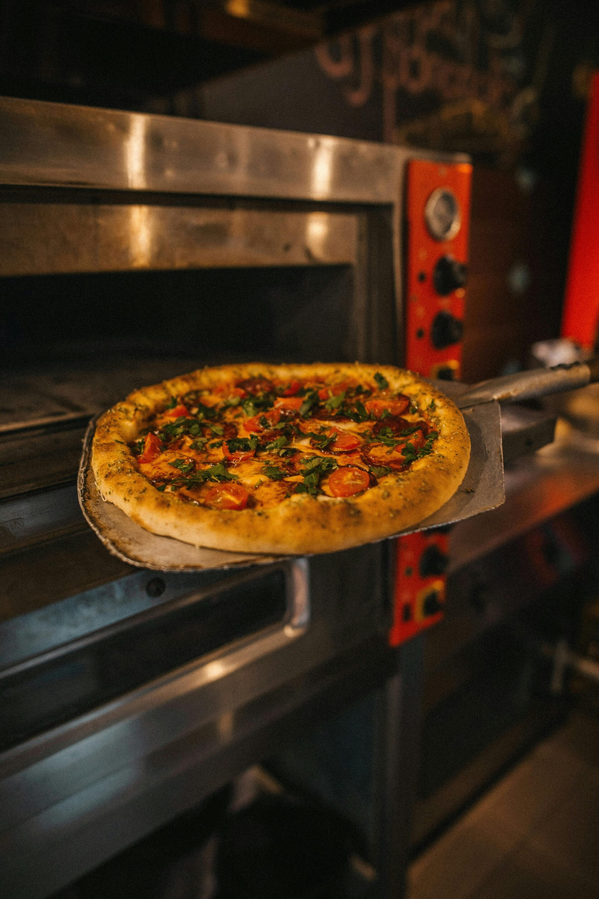 pizza-on-a-peel-beside-an-oven