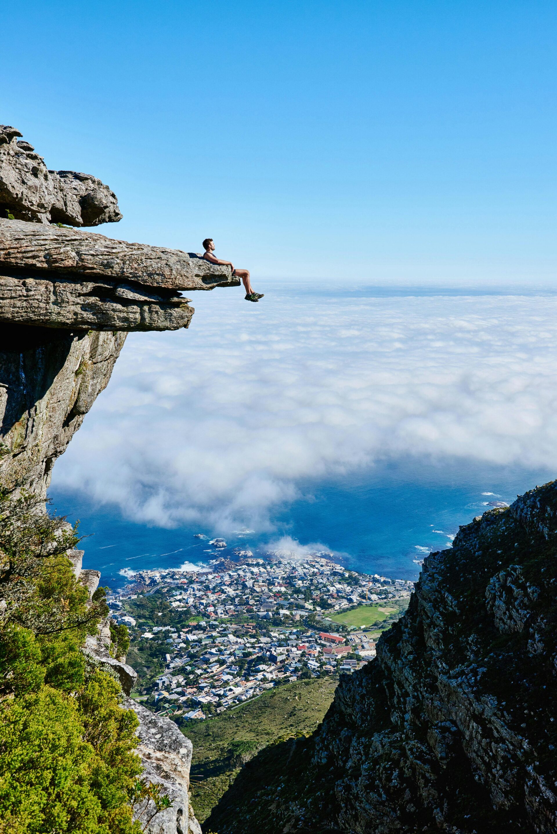 person-sitting-on-mountain-cliff